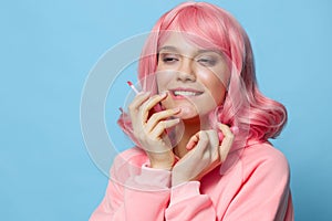beautiful woman with pink hair lipstick makeup blue background
