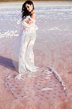 Beautiful woman on a pink lake.