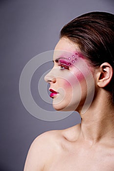 Beautiful woman with pink make up profile shot