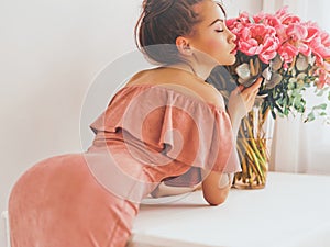 Beautiful woman with pink peonies