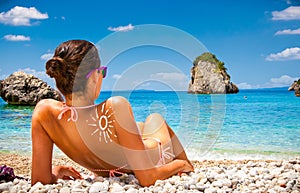 Woman on Piso Kryoneri beach in Parga, Greece. photo