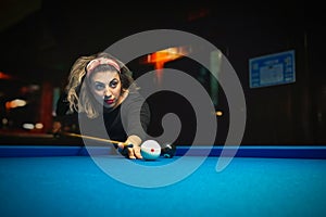 Beautiful woman play pool game