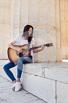 Beautiful Woman playing acoustic Guitar