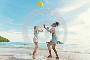 beautiful woman playing ball on the beach
