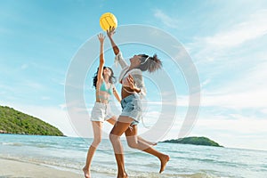 beautiful woman playing ball on the beach