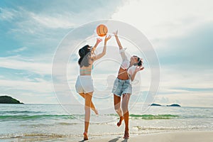 beautiful woman playing ball on the beach