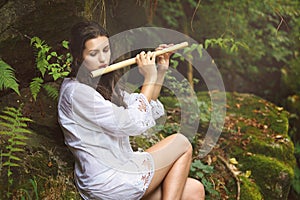 Beautiful woman playing flute after the rain