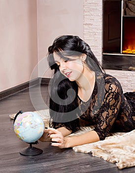 Beautiful woman playing with a globe