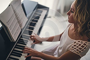 Beautiful woman playing piano