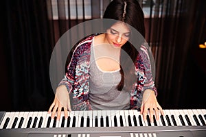 Beautiful woman playing on piano