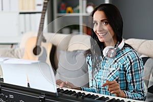 Beautiful woman playing piano on background