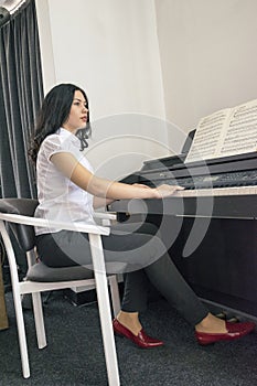 Beautiful woman playing piano