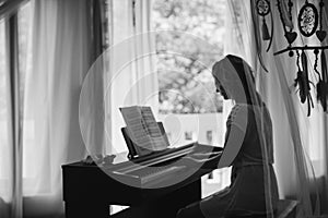 Beautiful woman playing piano. Black and white