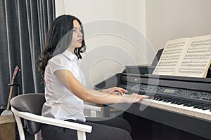 Beautiful woman playing piano