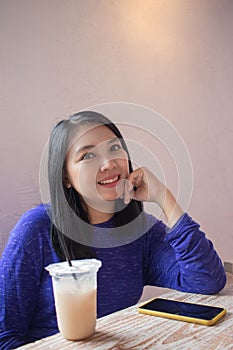 A beautiful woman is playing a smartphone