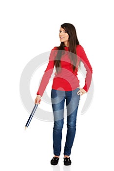 Beautiful woman pointing down with a big pencil.