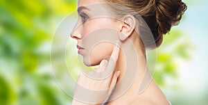 Beautiful woman pointing finger to her ear