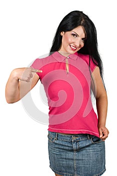 Beautiful woman pointing to her pink blank t-shirt