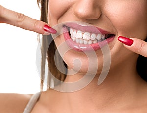 Beautiful woman pointing to her teeth