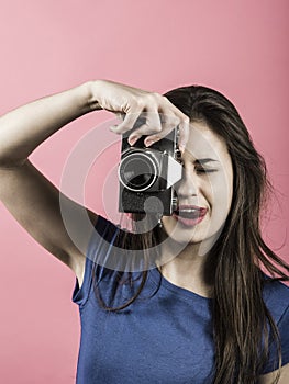 Beautiful woman pointing vintage camera