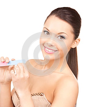 Beautiful woman polishing her nails