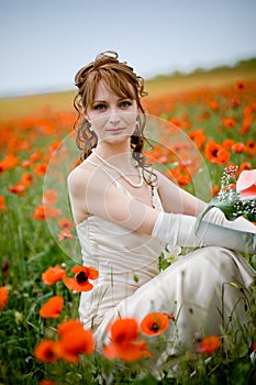 Beautiful woman in poppy field