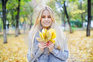 Beautiful woman portrait on autumn background photo