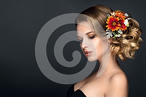 Beautiful woman portrait with autumn flowers in hair