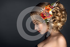 Beautiful woman portrait with autumn flowers in hair