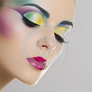 Beautiful woman portrait with bright colourful makeup