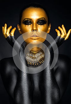 Beautiful woman portrait in gold and black colors