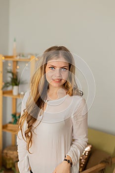 Beautiful woman portrait at home in modern interior.