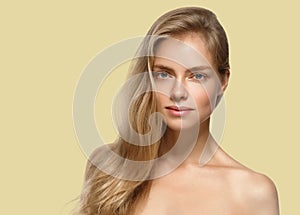 Beautiful woman portrait over yellow color background