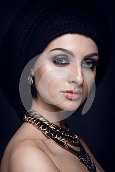 Beautiful woman portrait with scarf on head and jewelry