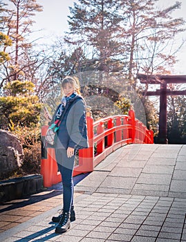 Beautiful Woman portrait in winter clothing with Japanese Temple shrine background for Sendai travel