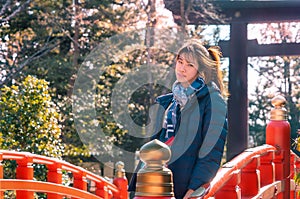 Beautiful Woman portrait in winter clothing with Japanese Temple shrine background for Sendai travel