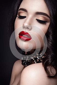 Beautiful woman portrait. Young lady posing close up on black background. Glamour make up, red lipstick.