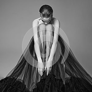 Beautiful woman pose in studio. Art portrait of a model in a bla