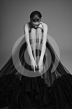 Beautiful woman pose in studio. Art portrait of a model in a black dress