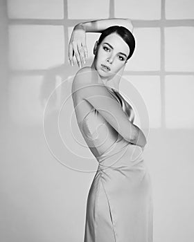 Beautiful woman pose in studio in classic dress