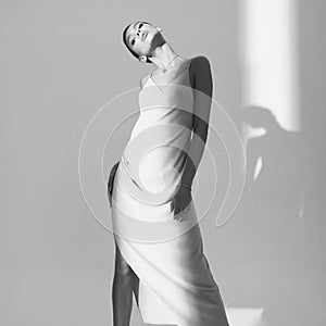 Beautiful woman pose in studio in classic dress