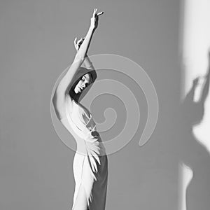 Beautiful woman pose in studio in classic dress