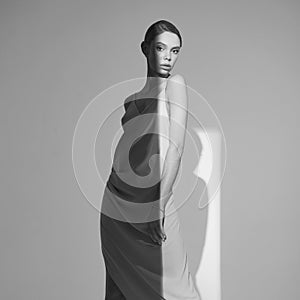 Beautiful woman pose in studio in classic dress