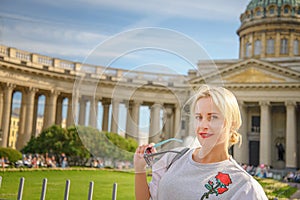 Beautiful woman posing over Kazan Cathedral in St. Petersburg