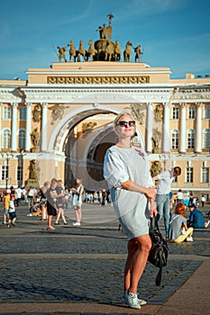 Beautiful woman posing over Palace Square in St. Petersburg