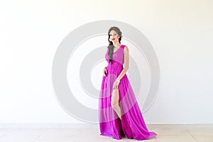 Beautiful woman posing in purple dress