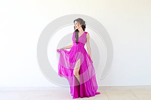 Beautiful woman posing in purple dress