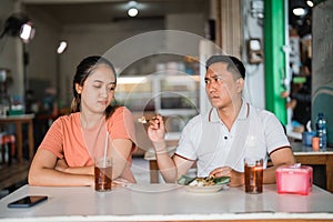 beautiful woman pouts when refused to be fed by boyfriend