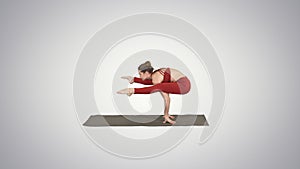Beautiful woman practices handstand yoga asana Tittibhasana - fi