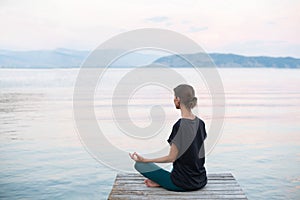 Beautiful woman practicing yoga near the sea, Young girl meditate at sunset on the beach.